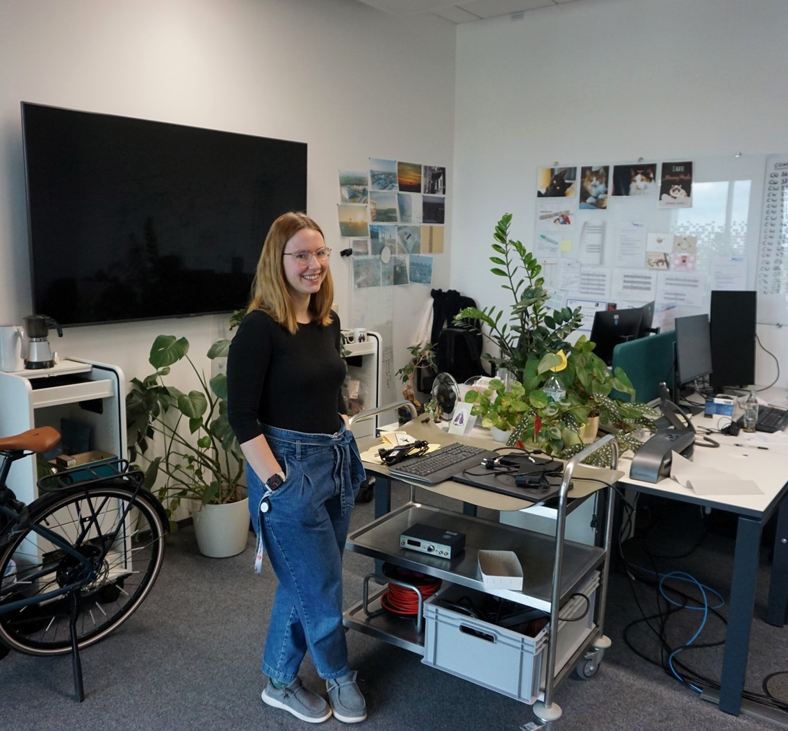 Rebecca in her office, where she has created a personal atmosphere with plants, photos and personal items.