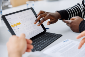 Hands pointing at a tablet