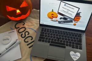 Laptop with Coscine presentation for the 3rd user meeting, surrounded by Halloween pumpkins and Coscine merchandise.