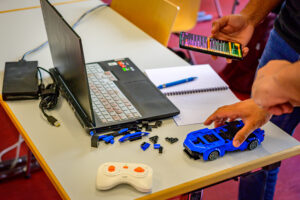 A table with a laptop and a building-block car on it