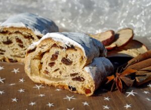 Christmas stollen on a table decorated with cloves and apples