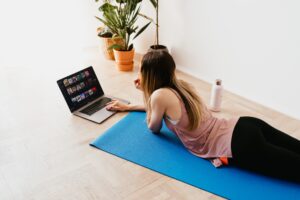 Woman in home office on a mat at the laptop