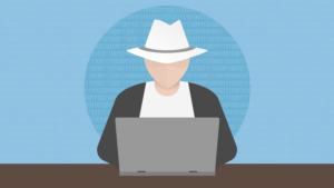 Man with hat in front of laptop