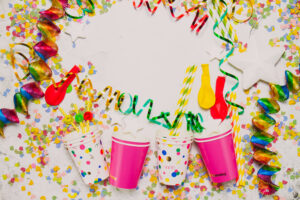 White background with pink glasses and party decoration