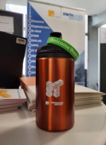 Insulated mug with IT Center key visual and Welcome Week wristband