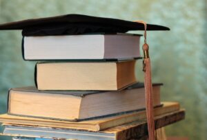 Schoolbooks with a bachelor hat