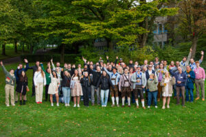 Group photo of IT Center employees at the 2025 Oktoberfest outdoors.