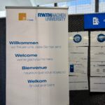 A banner with the word “Welcome” in eye-catching lettering and in several languages.